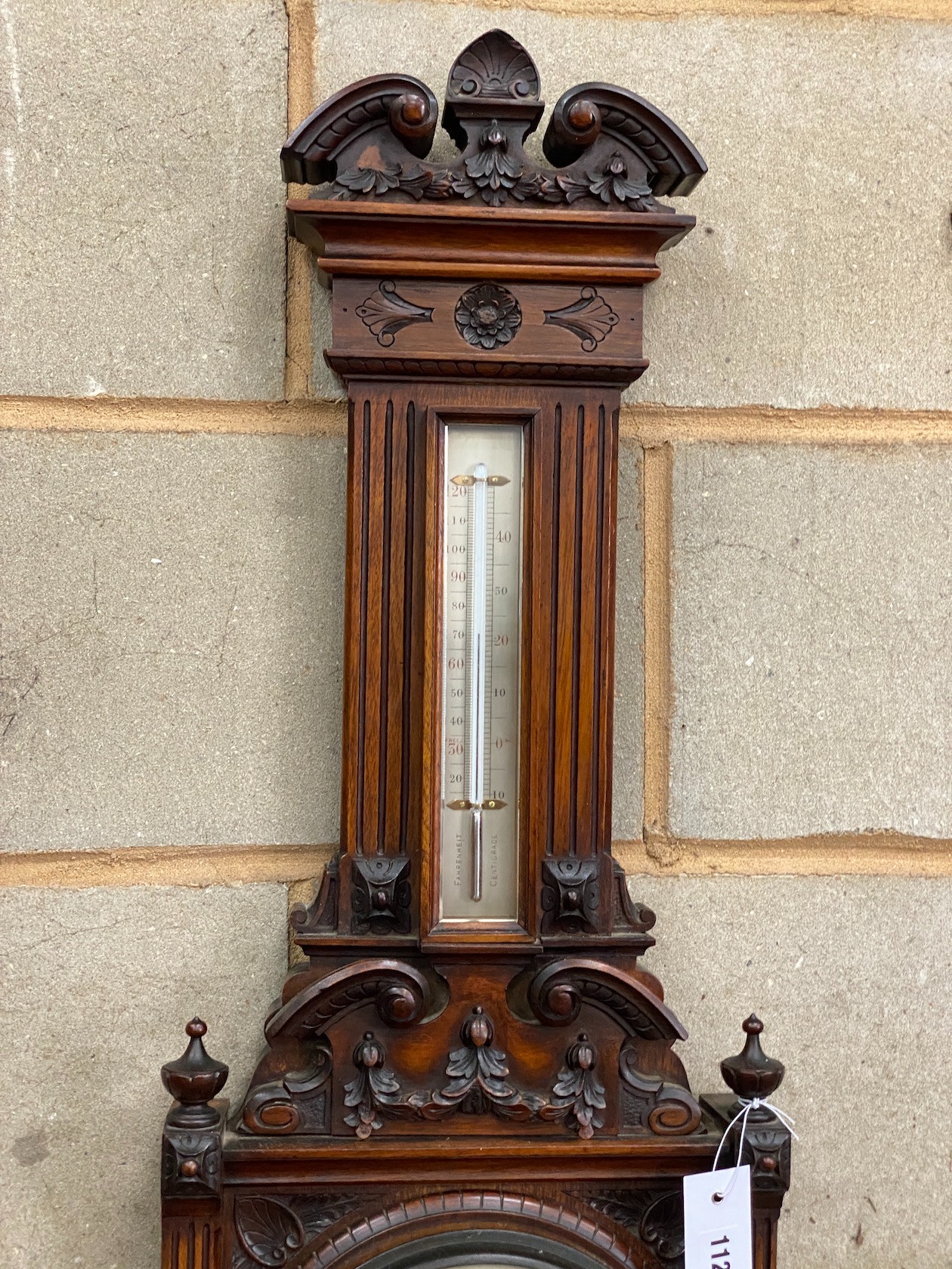 A late Victorian carved walnut aneroid barometer and thermometer, height 95cm